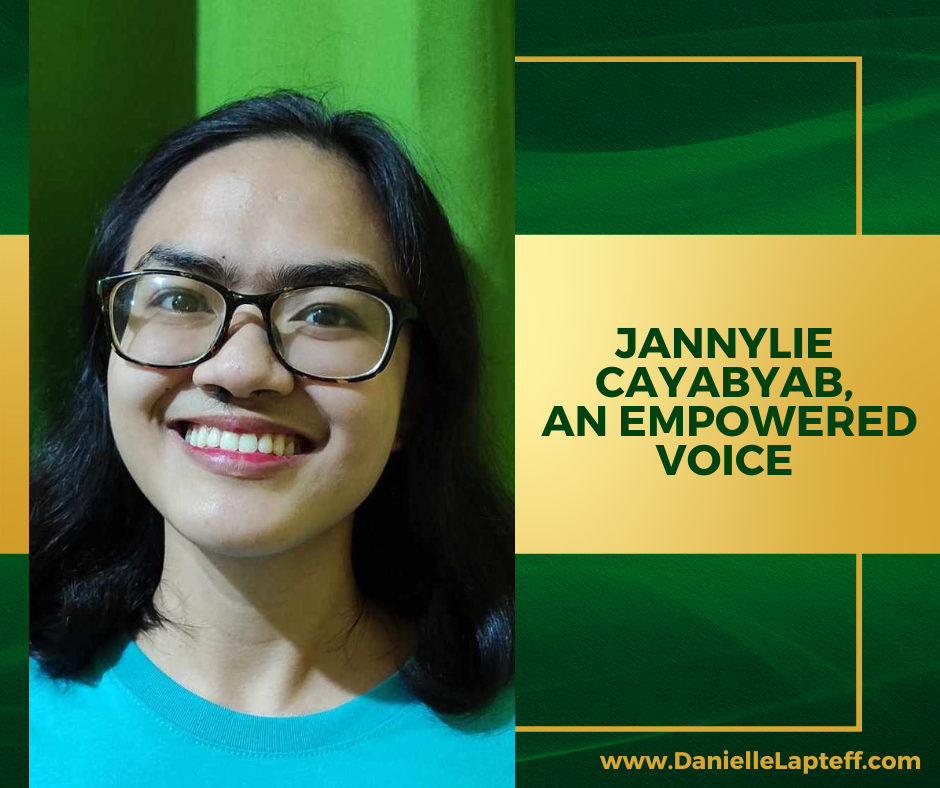 girl with glasses and dark hair, smiling, orange dress, green and gold background, Jannylie Cayabyab: An Empowered Voice