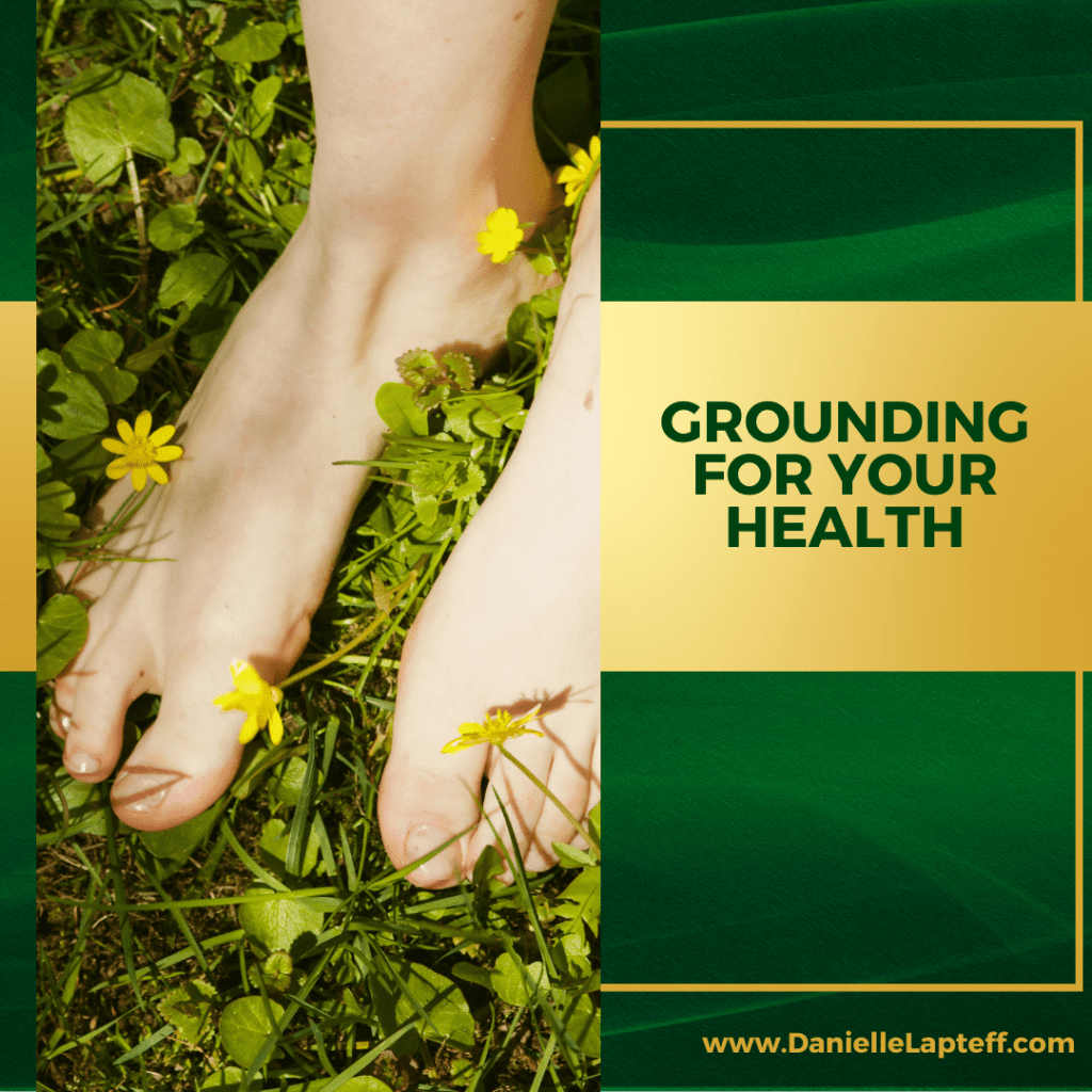 barefeet in the grass with flowers, a green and gold background and the words Grounding for your health.